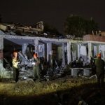 Israeli soldiers attend the scene of damage caused after Iranian missile barrages struck Dimona. (Reuters)