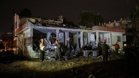 Israeli soldiers attend the scene of damage caused after Iranian missile barrages struck Dimona. (Reuters)