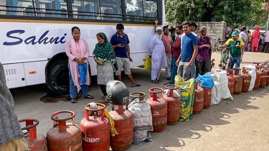 People queue up to avail LPG cylinders amid ongoing supply crunch, in Dilshad Colony, Delhi. (PTI)