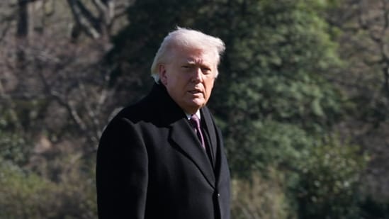 President Donald Trump walks on the South Lawn as he returns to the White House. (AP)