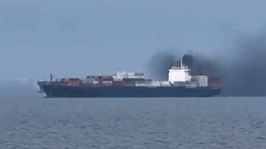 Smoke emerging from a cargo vessel, as filmed from another vessel, just north of Dubai. (Photo via AFP)