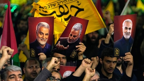 Iranians holding up posters of the late Islamic Revolutionary Guard Corps (IRG) chief Gen Qassem Soleimani, who was killed in a US drone attack in 2020, during an anti-Israeli gathering in 2024. He remains a folk hero since. (AP File Photo)