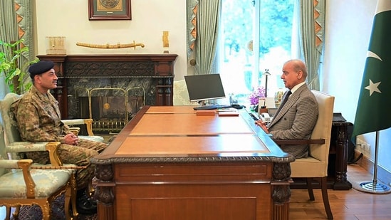 Pakistan’s Prime Minister Shehbaz Sharif (R) speaking with Army Chief and Field Marshal Asim Munir at the Prime Minister’s House in Islamabad. (AFP)