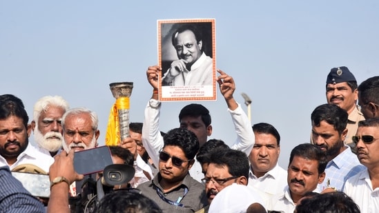 A supporter holds a portrait of former Maharashtra deputy chief minister Ajit Pawar during an event earlier this week. (PTI)