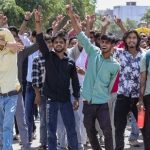 Factory workers during a protest demanding a hike in wages, in Noida, Gautam Buddh Nagar district, Uttar Pradesh, Monday, April 13, 2026. The protest carried incidents of arson, vandalism and stone-pelting reported from Phase-2 and Sector 60 areas, police said. (PTI)