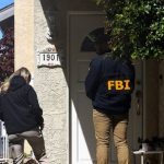 An FBI member stands outside a building next to the house associated with Cole Tomas Allen, the suspect in the shooting incident in Washington at the annual White House Correspondents’ Association dinner, in Torrance, California, U.S. (REUTERS)